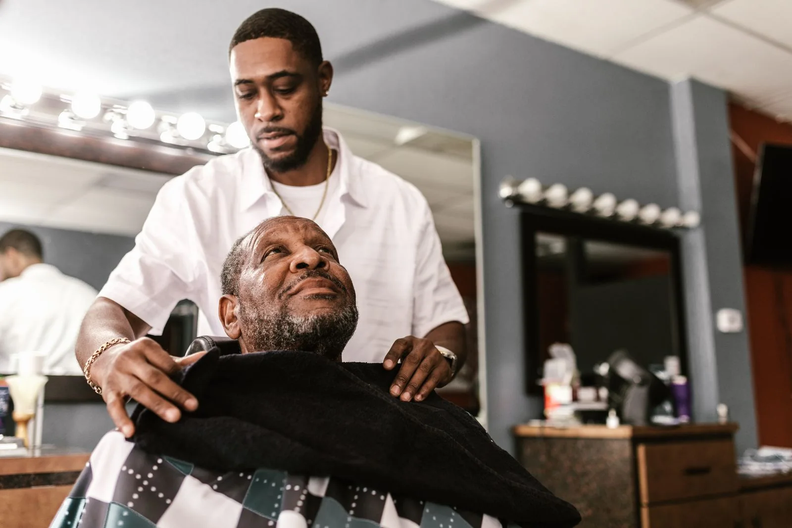 Barber preparing a client for grooming