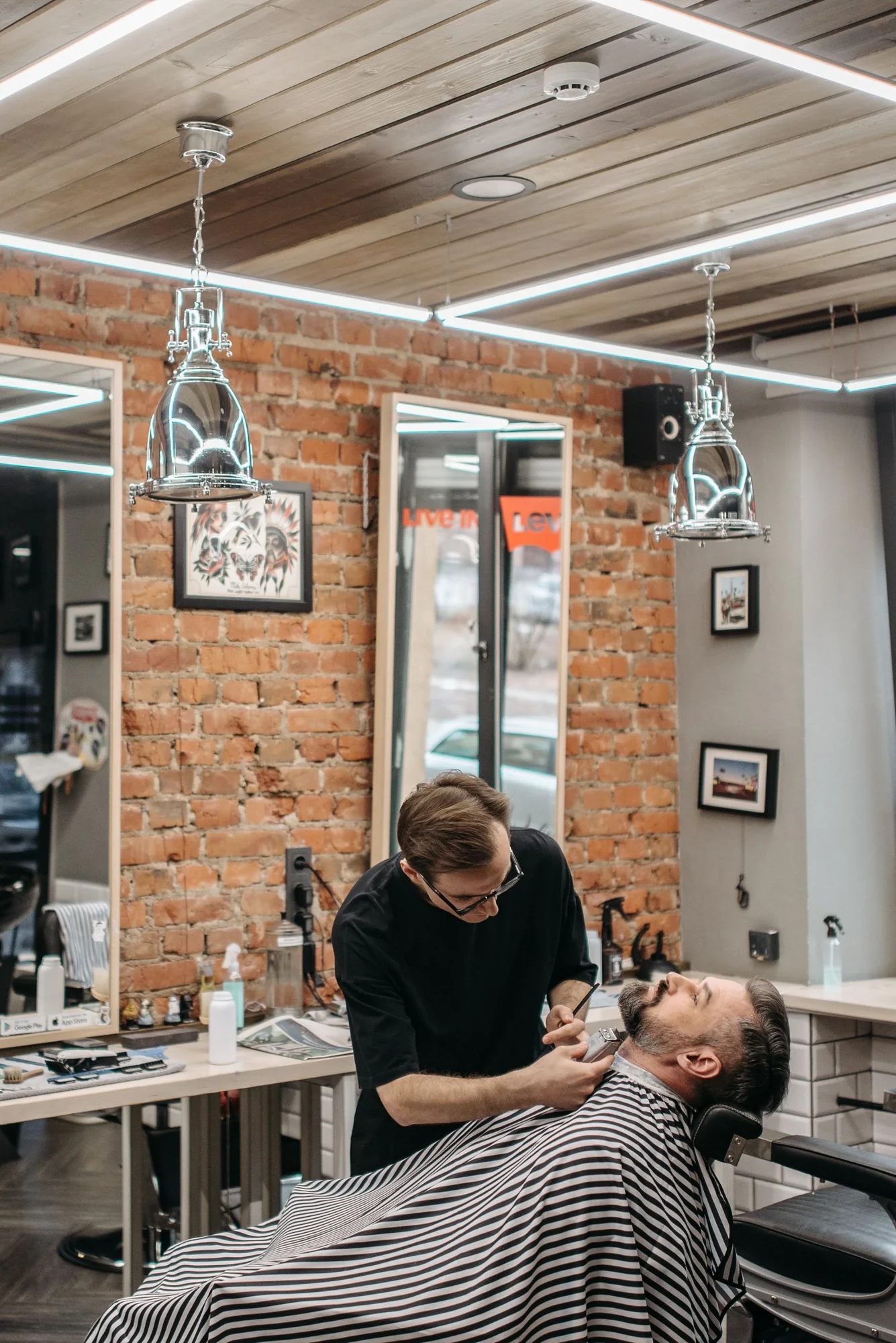 Barber refining a client’s beard