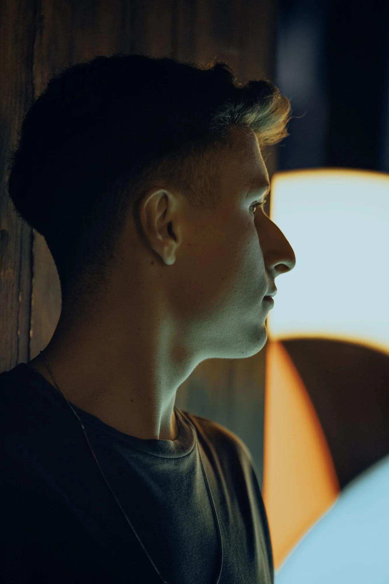 Side-profile portrait showing a short hairstyle